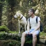 Tourist With Dog In The Forest